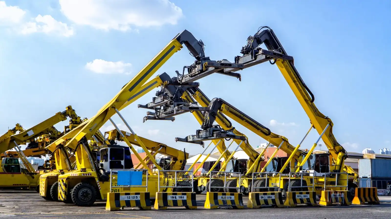 Heavy equipment rental in UAE - forklift and container handler at construction site in Dubai