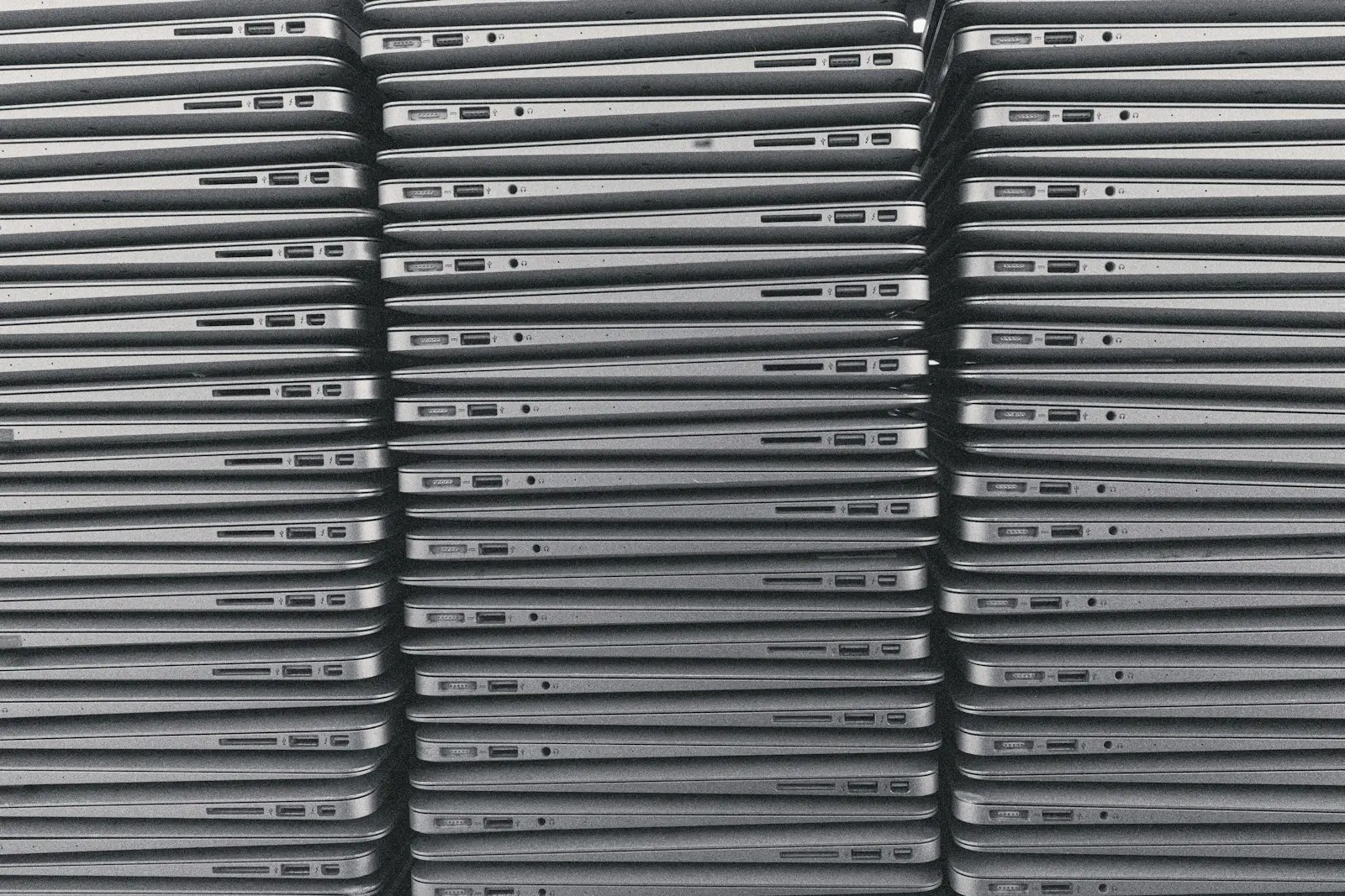 Stacks of laptops in a rental company's store, ready to go out
